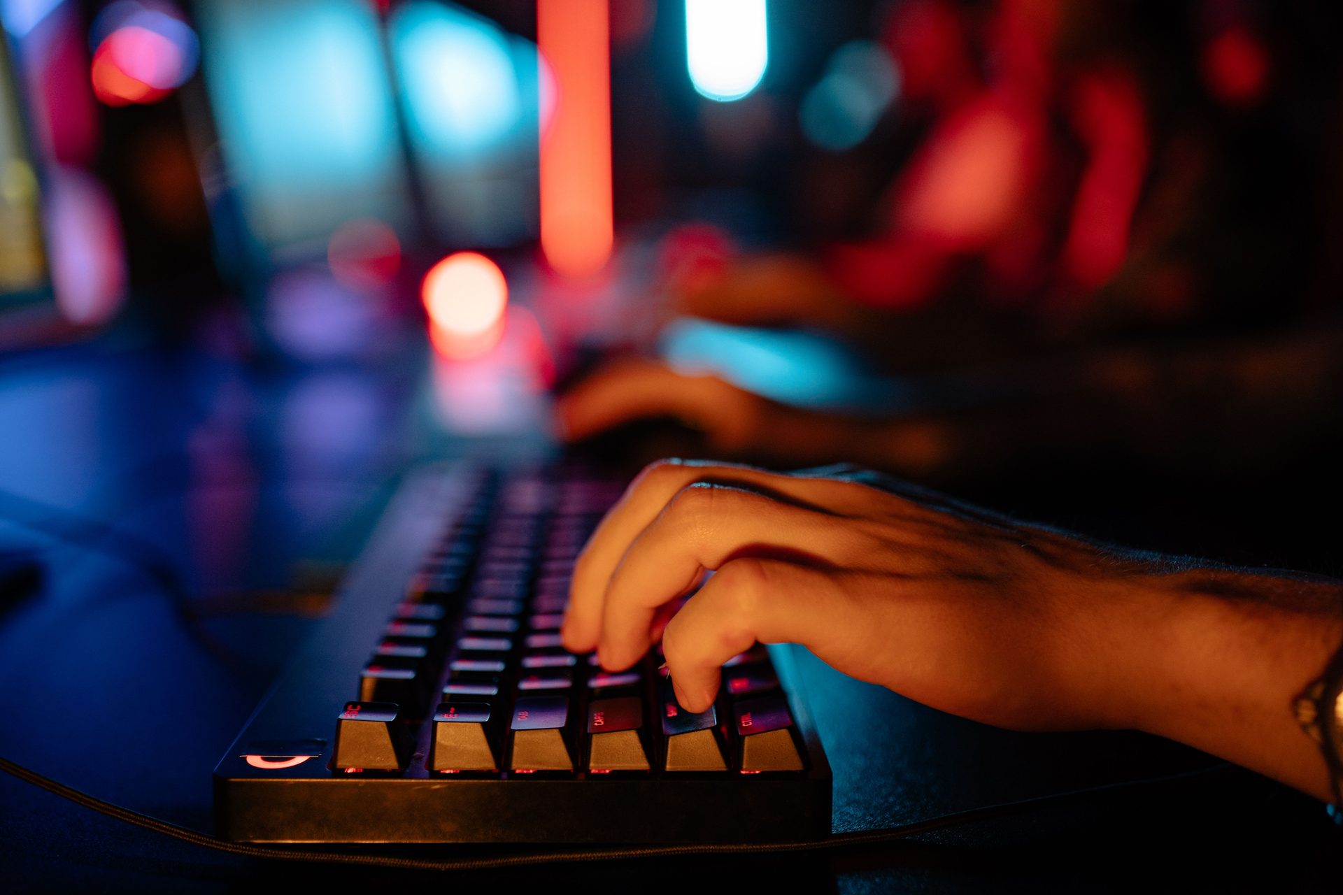 Close-up of a backlit mechanical keyboard at a Secret Level station